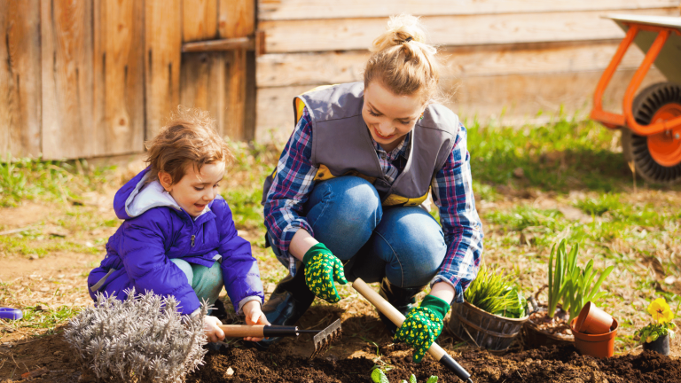 Compass Associates - a child with an adult doing some gardening