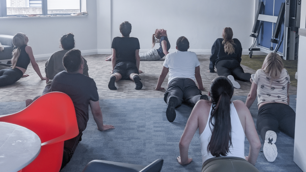 Compass Associates - World Wellbeing Week - members of the team taking part in a company yoga session