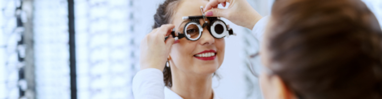 Compass Associates - Find an Expert - Ophthalmologist testing out glasses frames with a patient