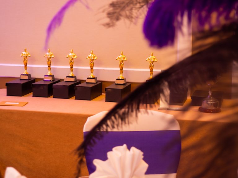 Compass Associates - Compass Core Values Awards 2022 on display and slightly covered by feather decorations